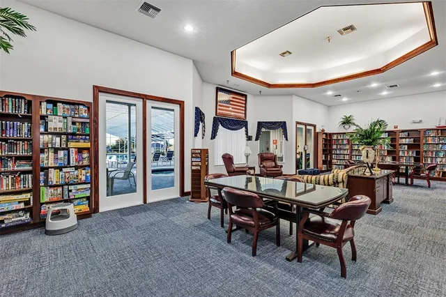 a view of a livingroom with furniture and a bookshelf