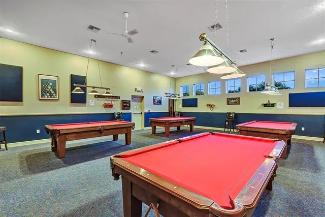 a room with furniture pool table and window