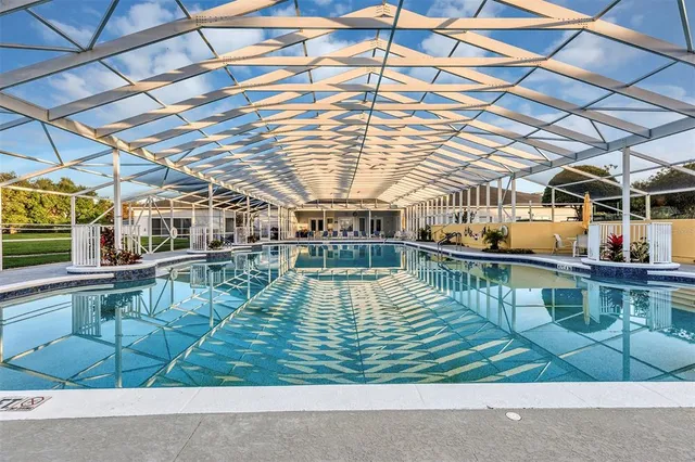 a view of a swimming pool with a deck and a patio