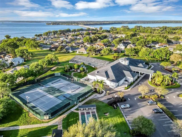 an aerial view of a residential apartment building with swimming pool and ocean view