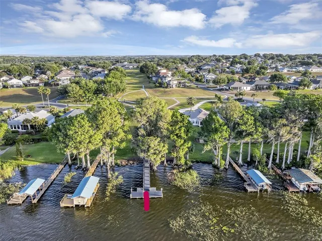 an aerial view of a house with a yard basket ball court and outdoor seating