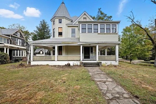a front view of a house with a garden