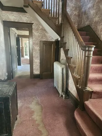a view of a livingroom with furniture and staircase