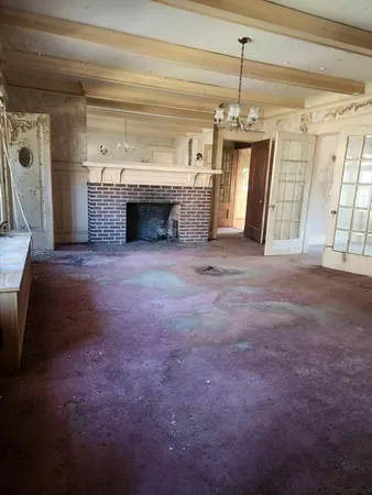 a view of an empty room with a fireplace