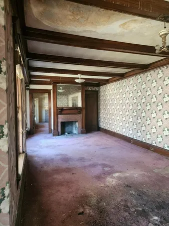 a view of empty room with a fireplace