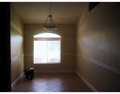17241 Southwest 285th Street Homestead, FL 33030 - Photo 5 of 14 a room with a window and a ceiling fan