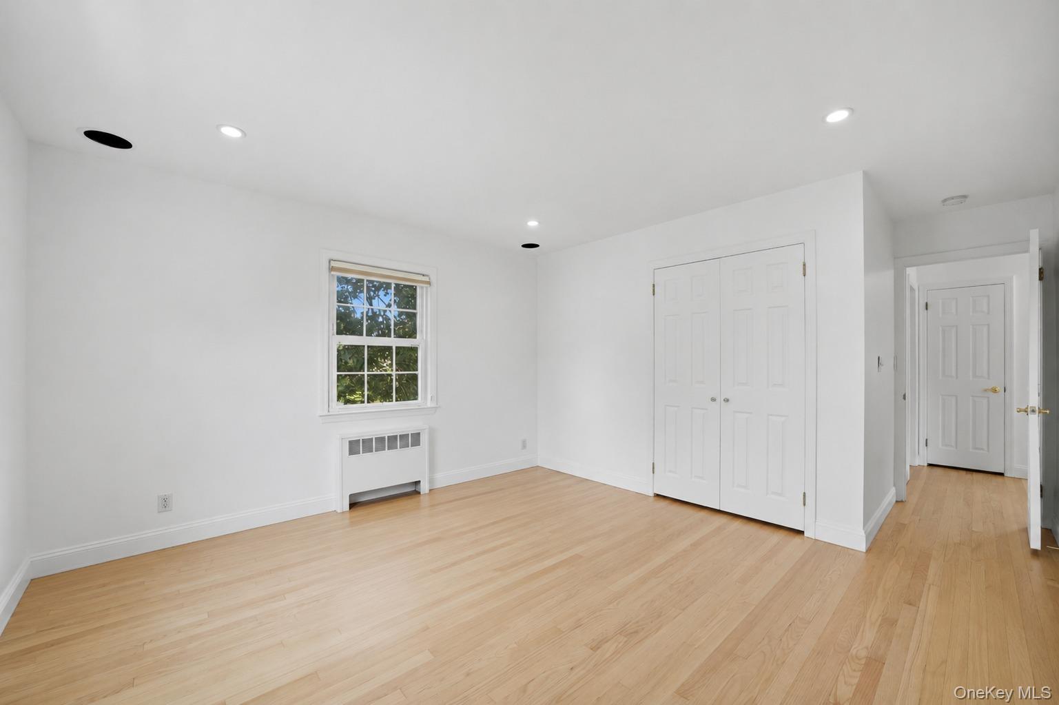 144 Bell Road Scarsdale, NY 10583 - Photo 27 of 49 Bright 2nd bedroom featuring light wood-finish flooring, white walls, and a window with natural light