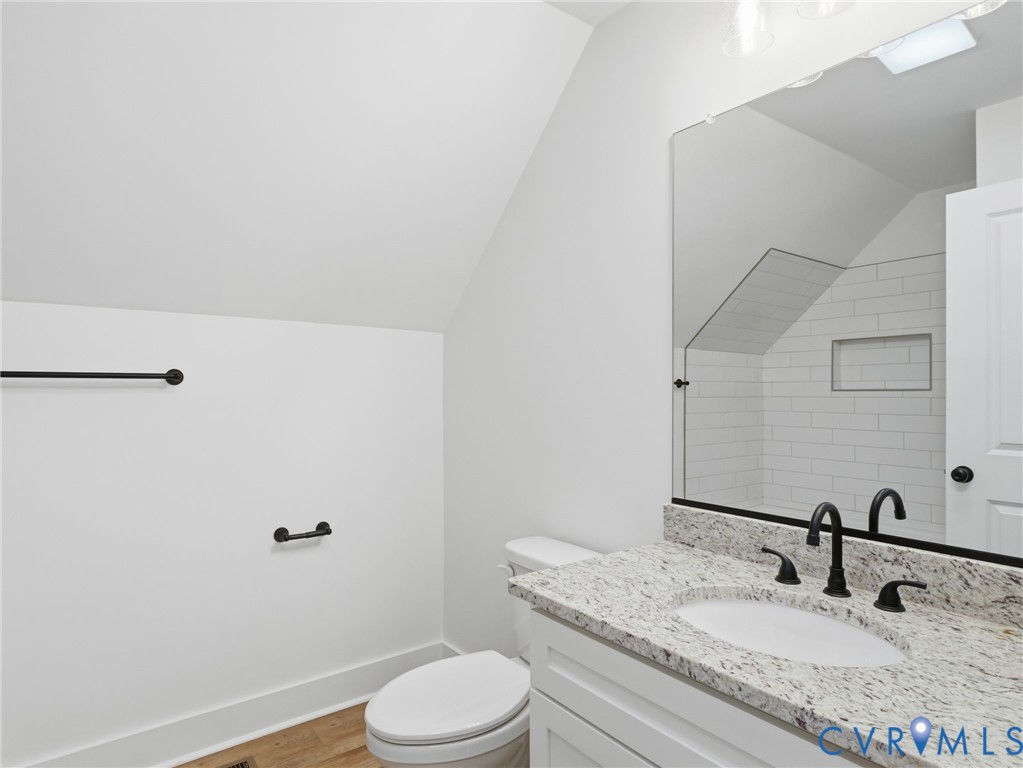 4301 Worsham Road Powhatan, VA 23139 - Photo 30 of 33 a bathroom with a granite countertop sink a toilet and mirror