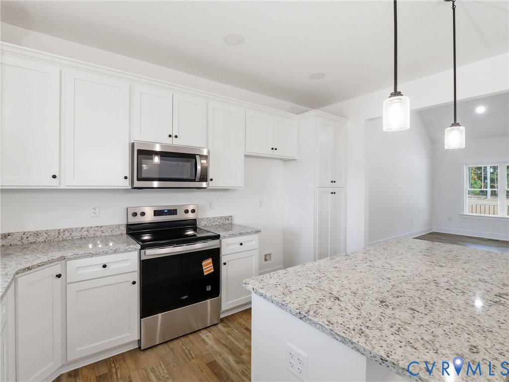 4301 Worsham Road Powhatan, VA 23139 - Photo 7 of 33 a kitchen with stainless steel appliances granite countertop a sink a stove a microwave and cabinets