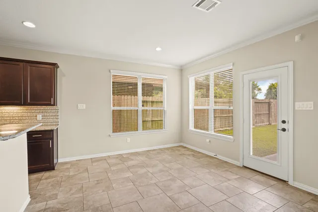 a kitchen with stainless steel appliances granite countertop wooden cabinets a stove top oven a sink and dishwasher