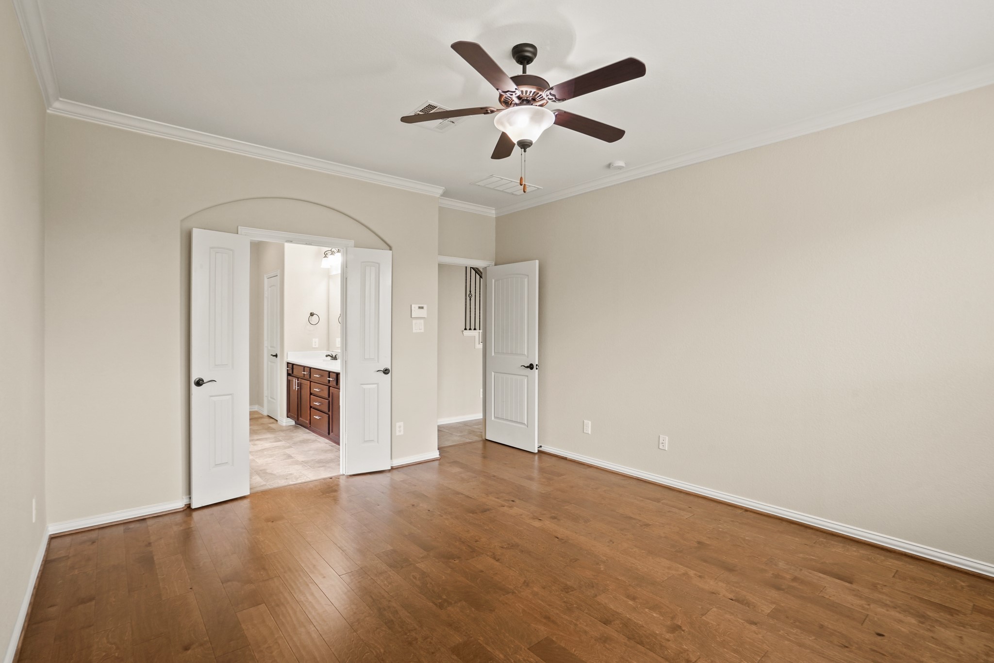 3414 Satton Ranch Lane Fulshear, TX 77441 - Photo 11 of 28 an empty room with wooden floor and a ceiling fan