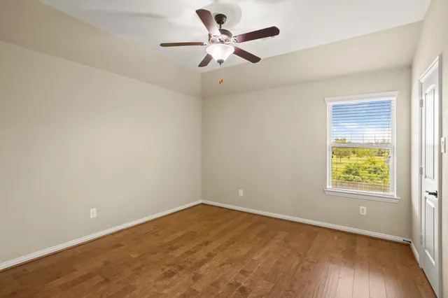 a view of a room with a sink and wooden floor