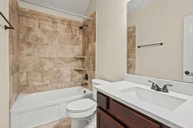 an empty room with a window and a ceiling fan