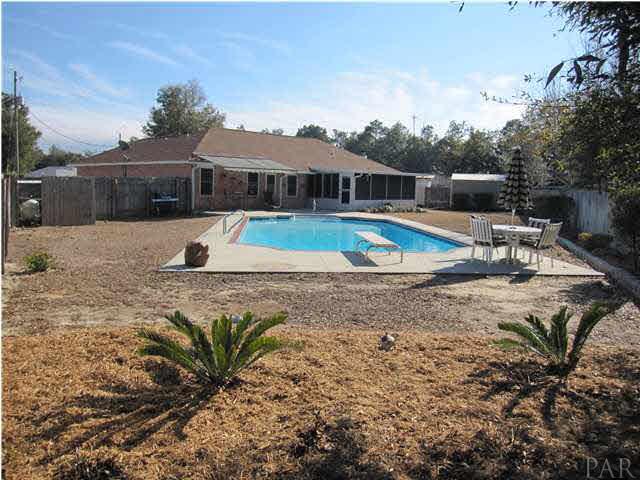 5987 Ridge Crest Court Milton, FL 32570 - Photo 20 of 24 Pool pump is tucked behind fence wall to the left.