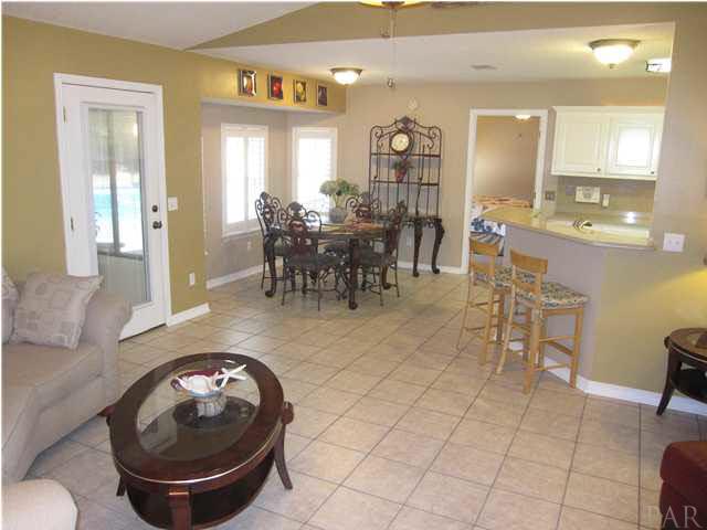 5987 Ridge Crest Court Milton, FL 32570 - Photo 3 of 24 Eat-in kitchen view from hallway by additional bedrooms. Doorway to the right of dining table leads to the master suite.