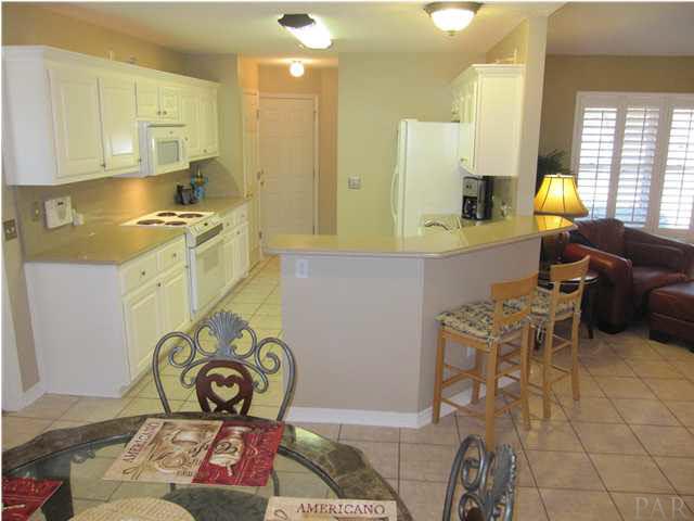 5987 Ridge Crest Court Milton, FL 32570 - Photo 6 of 24 Kitchen view with beautiful Granite countertops. Door ahead leads to garage. Laundry room to the right of garage.