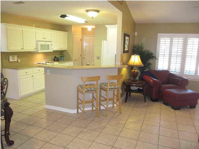 5987 Ridge Crest Court Milton, FL 32570 - Photo 7 of 24 Tile flooring is carried throughout family room, kitchen, Florida room, laundry room & bathrooms.