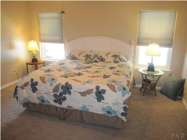 5987 Ridge Crest Court Milton, FL 32570 - Photo 9 of 24 Master bedroom. Windows look out to a beautiful view of the pool.
