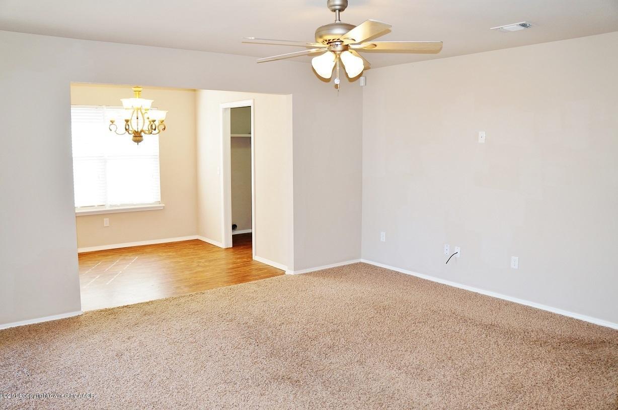 4814 Mammoth Lane Amarillo, TX 79110 - Photo 5 of 19 an empty room with windows and ceiling fan
