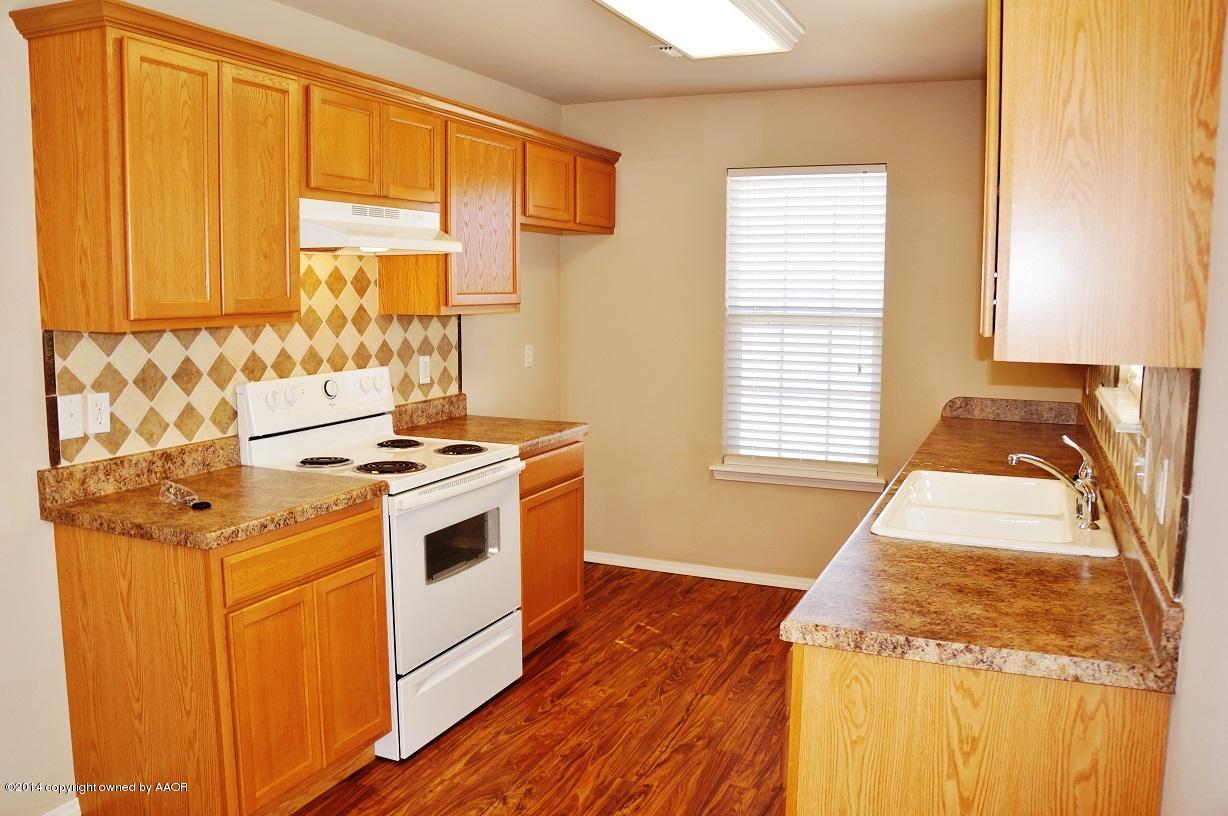 4814 Mammoth Lane Amarillo, TX 79110 - Photo 8 of 19 a kitchen with stainless steel appliances granite countertop a stove and a white cabinets