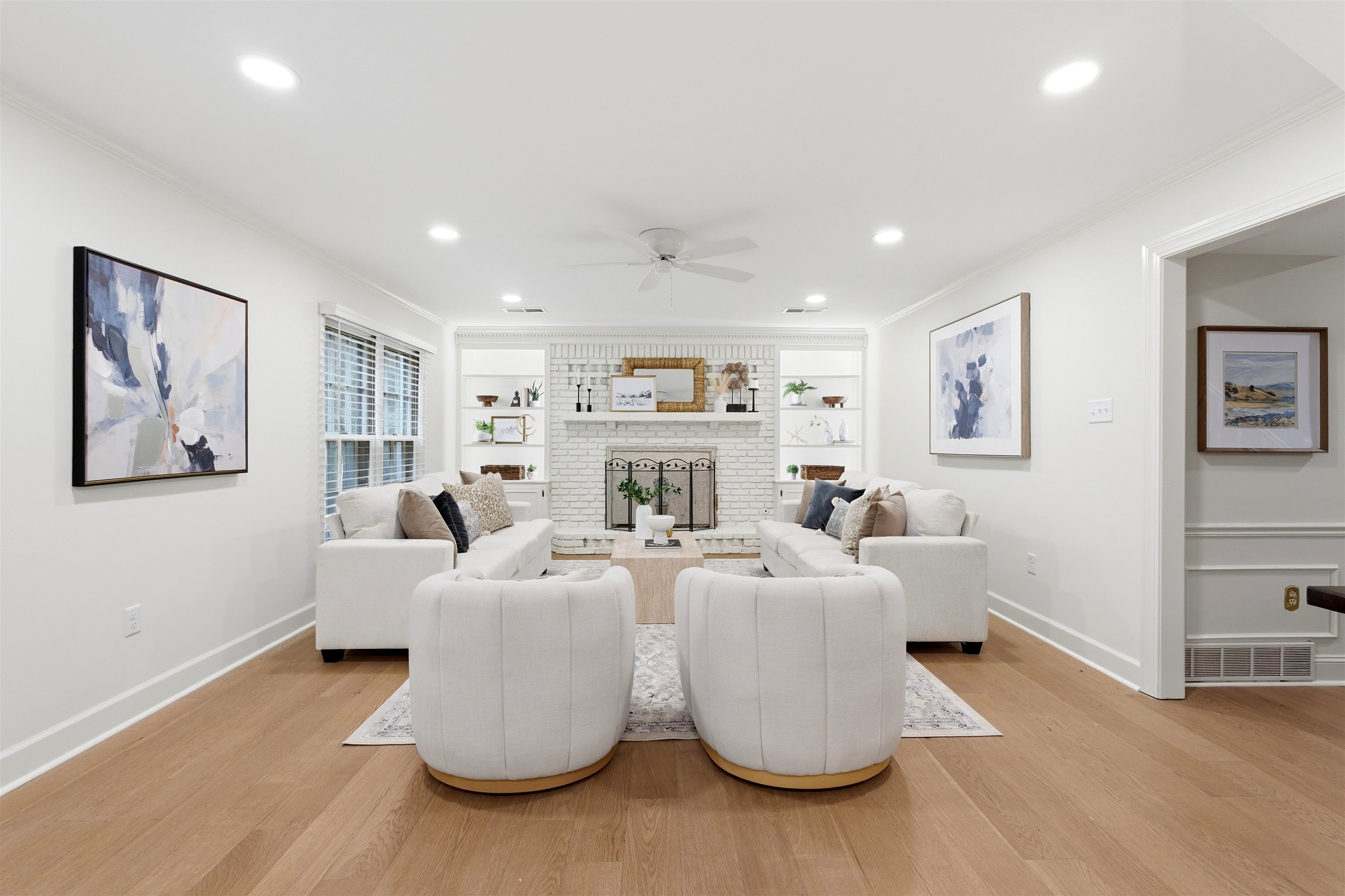 1984 Allenby Road Germantown, TN 38139 - Photo 15 of 37 Spacious living area featuring light wood-finish flooring, a white brick fireplace with a mantel, built-in shelving, recessed lighting, and a ceiling fan