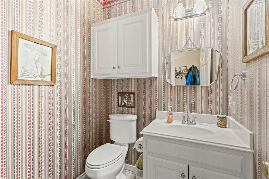 145 Indian Trail Decatur, TX 76234 - Photo 22 of 40 a white toilet sitting next to a bathroom sink