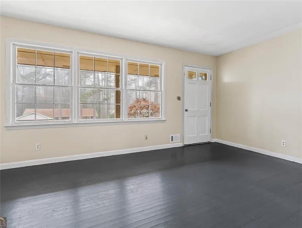 4334 Greenleaf Circle Southwest Atlanta, GA 30331 - Photo 3 of 12 an empty room with wooden floor and windows