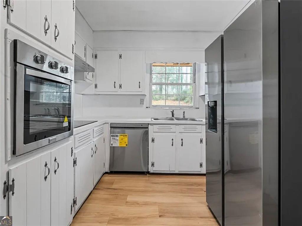 4334 Greenleaf Circle Southwest Atlanta, GA 30331 - Photo 4 of 12 a kitchen with stainless steel appliances a refrigerator sink and cabinets