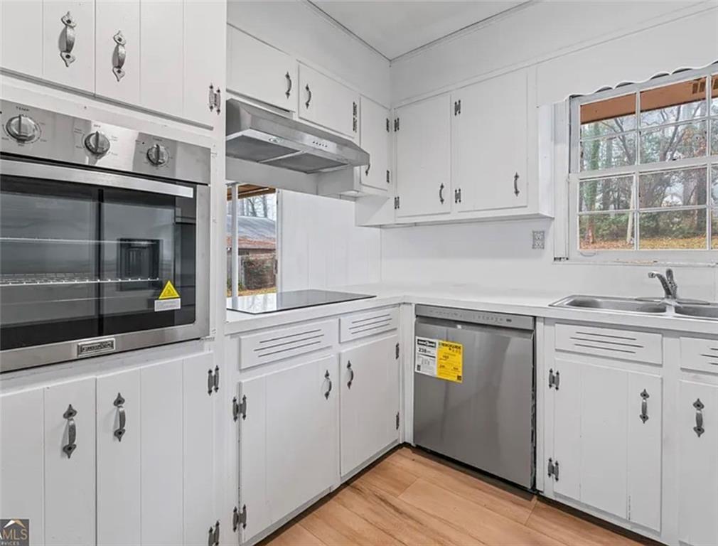 4334 Greenleaf Circle Southwest Atlanta, GA 30331 - Photo 5 of 12 a kitchen with stainless steel appliances white cabinets and a window