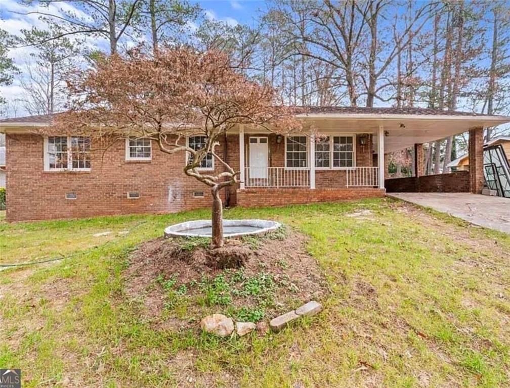 4334 Greenleaf Circle Southwest Atlanta, GA 30331 - Photo 10 of 12 a front view of a house with a garden and yard