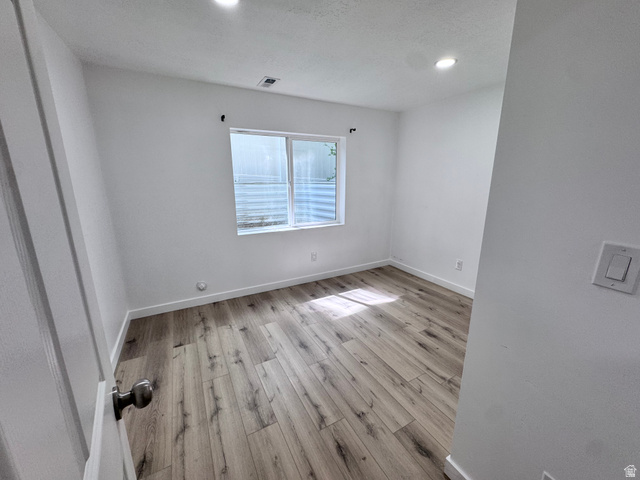 12339 Remy Road, Unit 422 Herriman, UT 84096 - Photo 34 of 36 Unfurnished room with light wood-style floors and recessed lighting