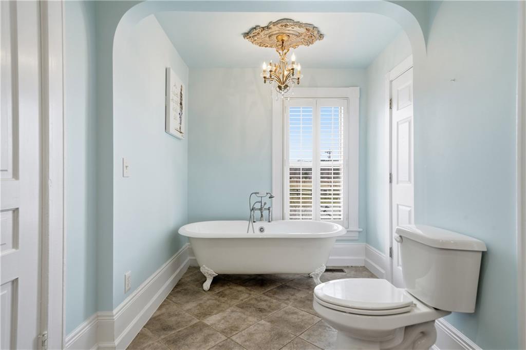 880 Johnstonville Road Barnesville, GA 30204 - Photo 17 of 33 a spacious bathroom with a granite countertop toilet a sink and a mirror