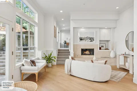 a living room with furniture a rug and kitchen view