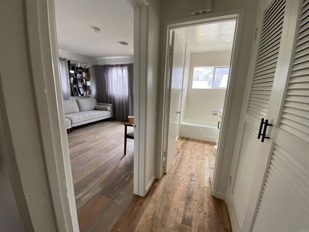 2159-65 Avenida De La Playa La Jolla, CA 92037 - Photo 16 of 42 a view of a hallway view with wooden floor and staircase