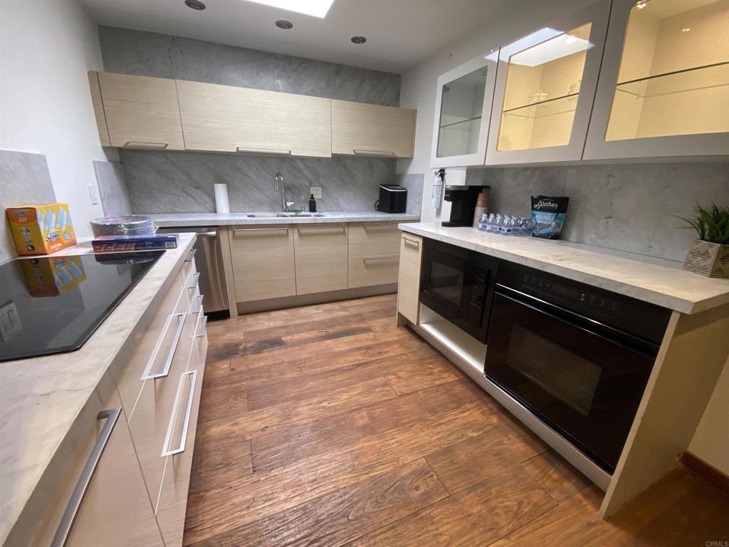 2159-65 Avenida De La Playa La Jolla, CA 92037 - Photo 18 of 42 a kitchen with stainless steel appliances granite countertop a sink a stove and a refrigerator