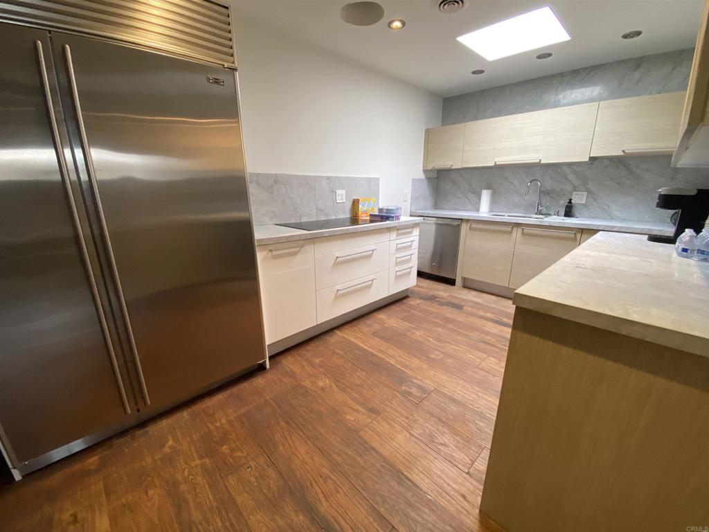 2159-65 Avenida De La Playa La Jolla, CA 92037 - Photo 22 of 42 a large kitchen with a refrigerator a sink and dishwasher