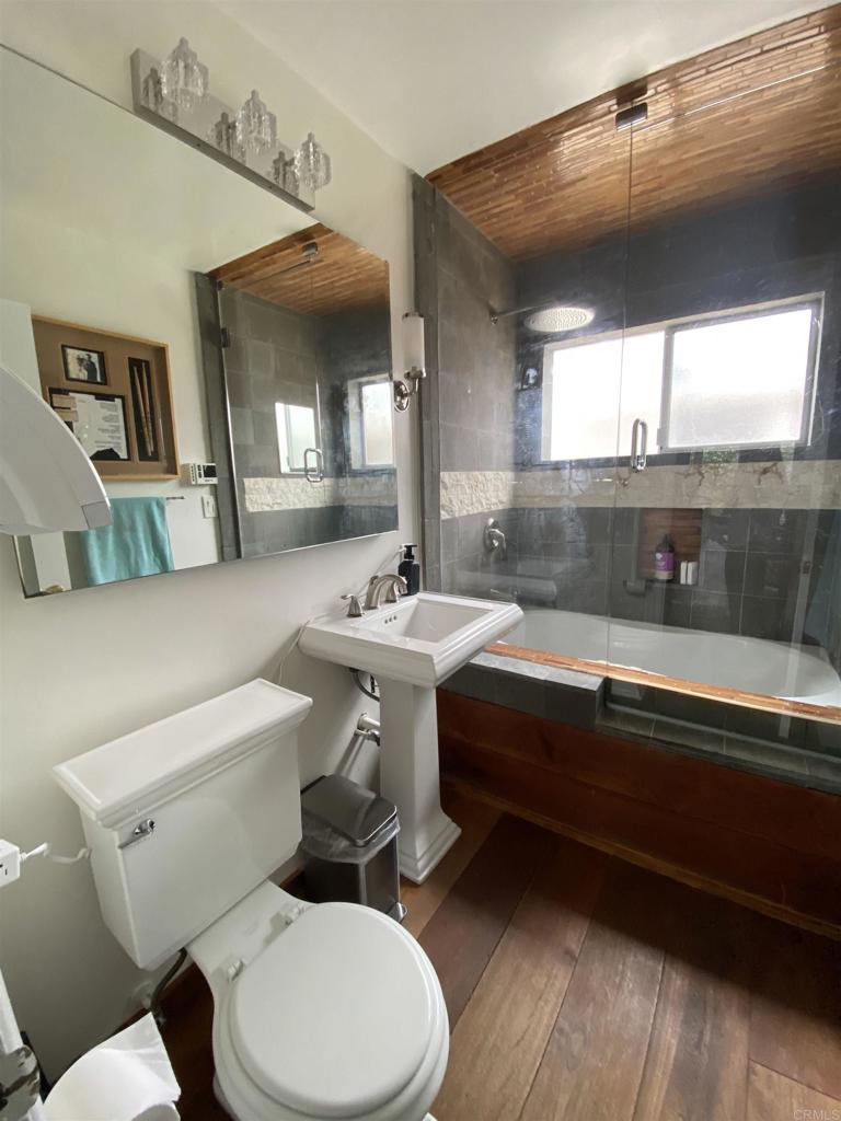 2159-65 Avenida De La Playa La Jolla, CA 92037 - Photo 24 of 42 a bathroom with a sink a toilet and mirror