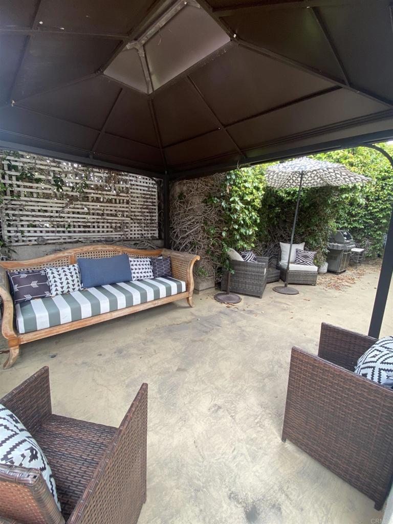 2159-65 Avenida De La Playa La Jolla, CA 92037 - Photo 27 of 42 a view of patio with a table under an umbrella