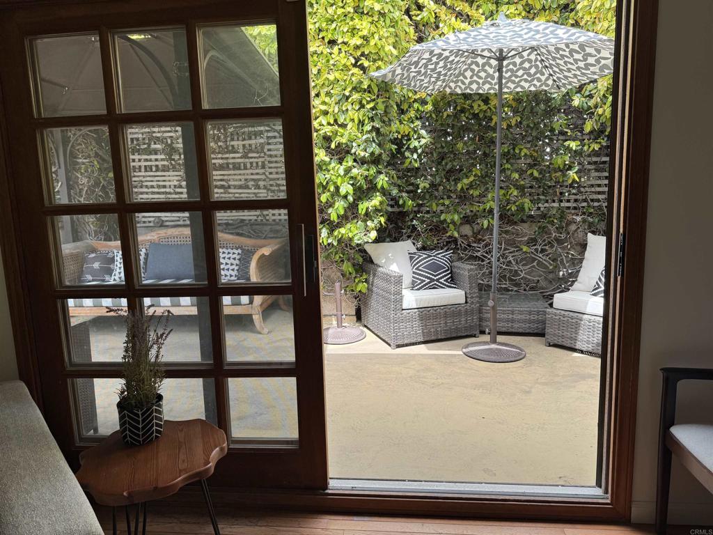 2159-65 Avenida De La Playa La Jolla, CA 92037 - Photo 36 of 42 a view of a porch with furniture and garden