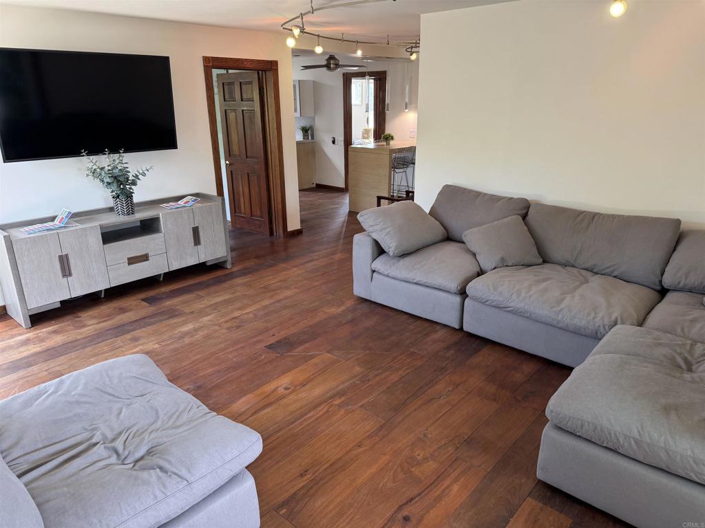 2159-65 Avenida De La Playa La Jolla, CA 92037 - Photo 42 of 42 a living room with furniture and a flat screen tv