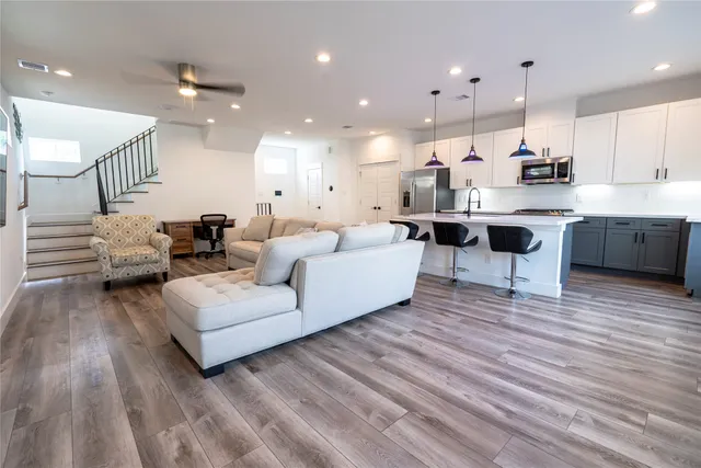 a living room with furniture and kitchen view