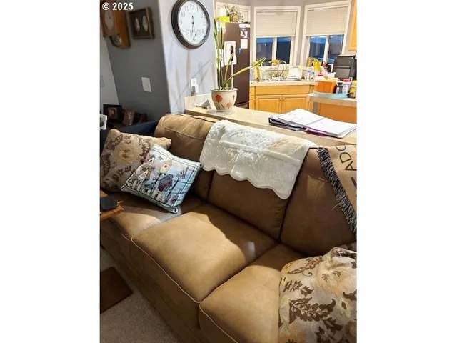 a living room with furniture and a clock