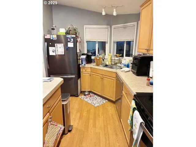 a view of a kitchen with sink and microwave