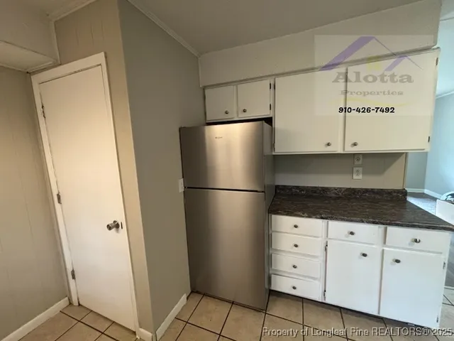 a kitchen with cabinets and stainless steel appliances