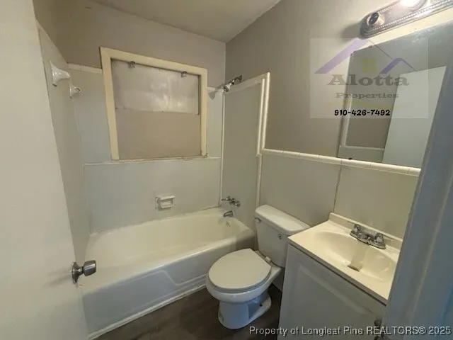 a bathroom with a toilet sink and shower