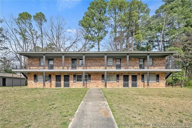 a front view of residential houses with yard