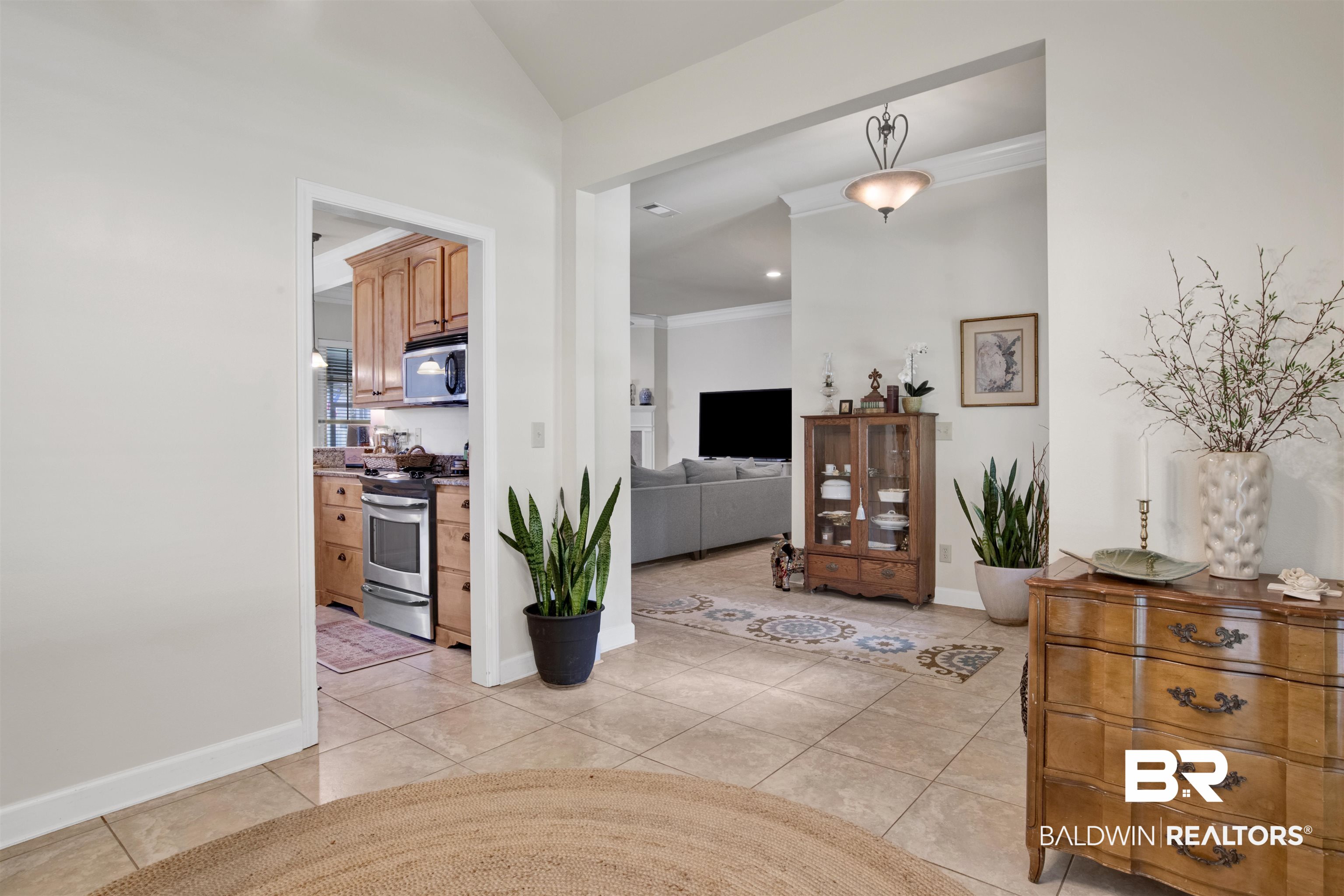10368 Gayfer Rd Extension Fairhope, AL 36532 - Photo 15 of 43 Spacious open-concept interior featuring light-toned tile flooring, neutral wall finishes, and vaulted ceilings