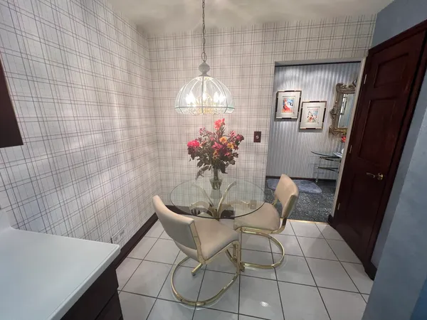 a dining room with furniture and chandelier