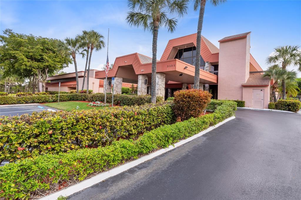 a front view of a house with a yard and potted plants