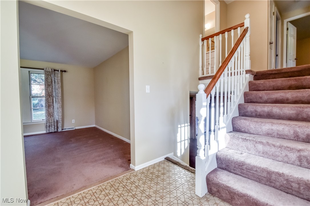 6145 Hemingway Road Cleveland, OH 44143 - Photo 5 of 50 Stairs with carpet and vaulted ceiling
